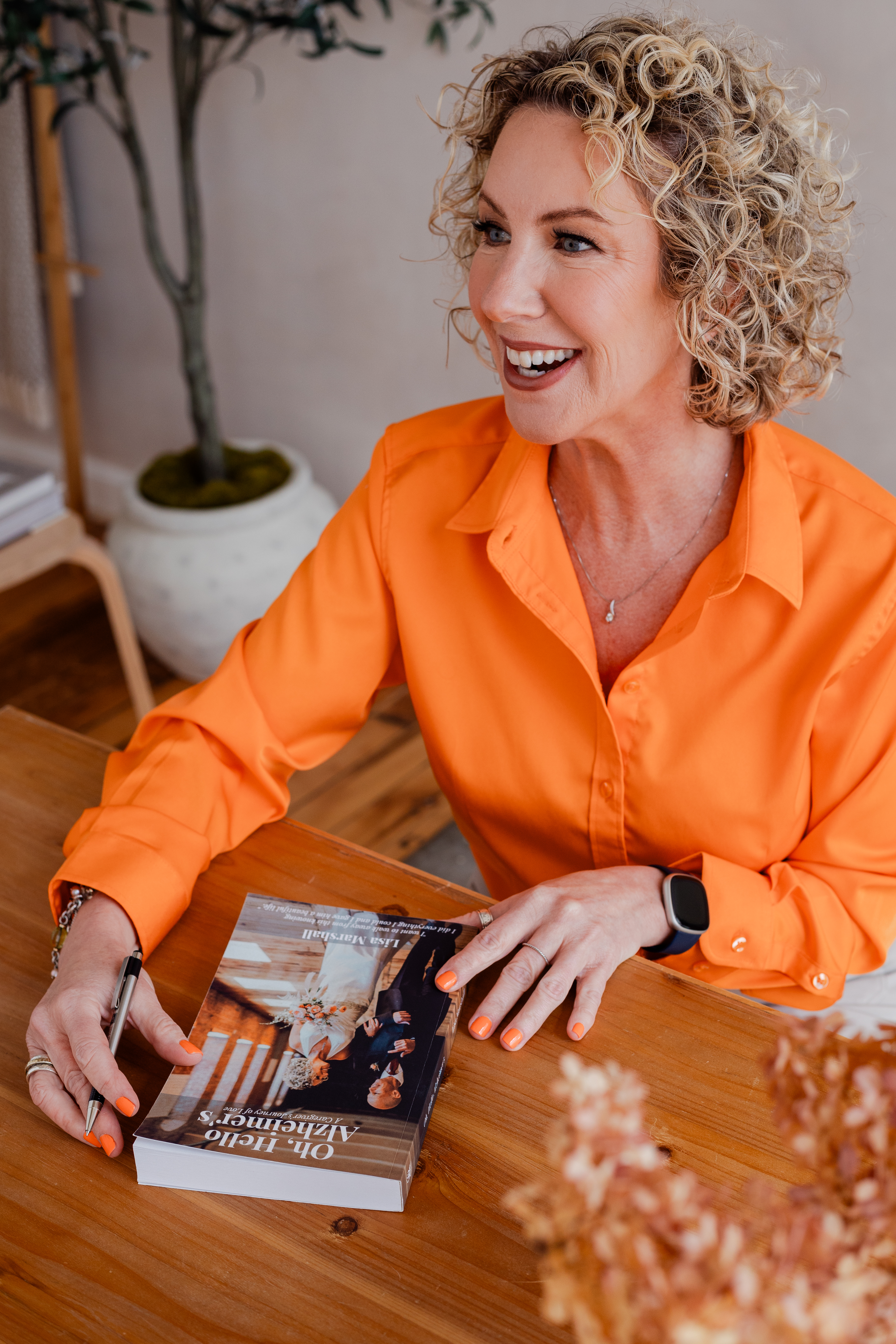 Lisa Marshall holding her book Find Joy. No Regrets.